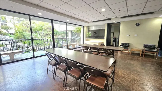 a living room with furniture a table and a large window