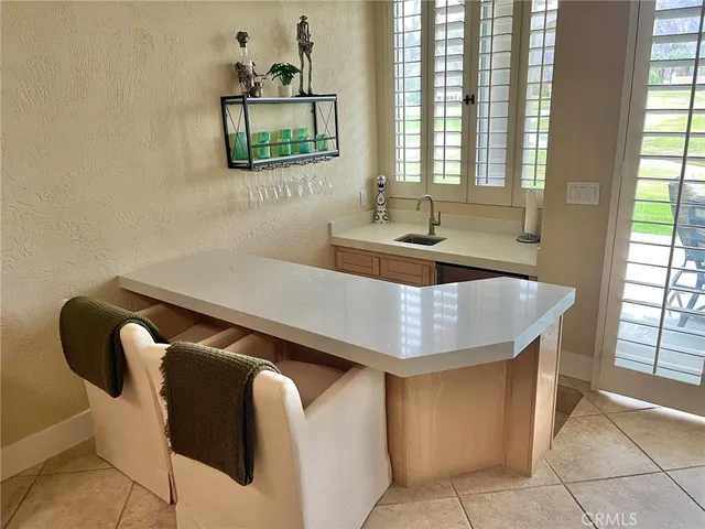 a kitchen with a table chairs and a window