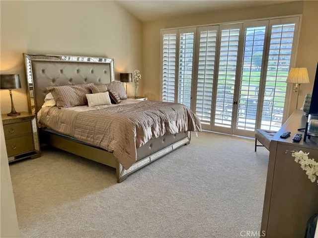 a spacious bedroom with a bed and window