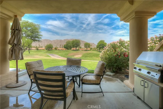 a view of a chairs and table in a terrace