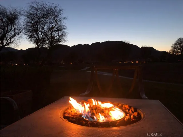 a view of a lake with a yard and a large trees
