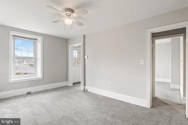 a kitchen with white cabinets and sink
