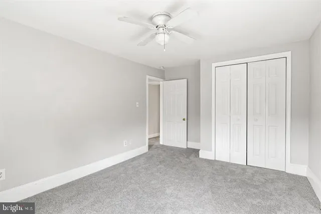 an empty room with windows and closet