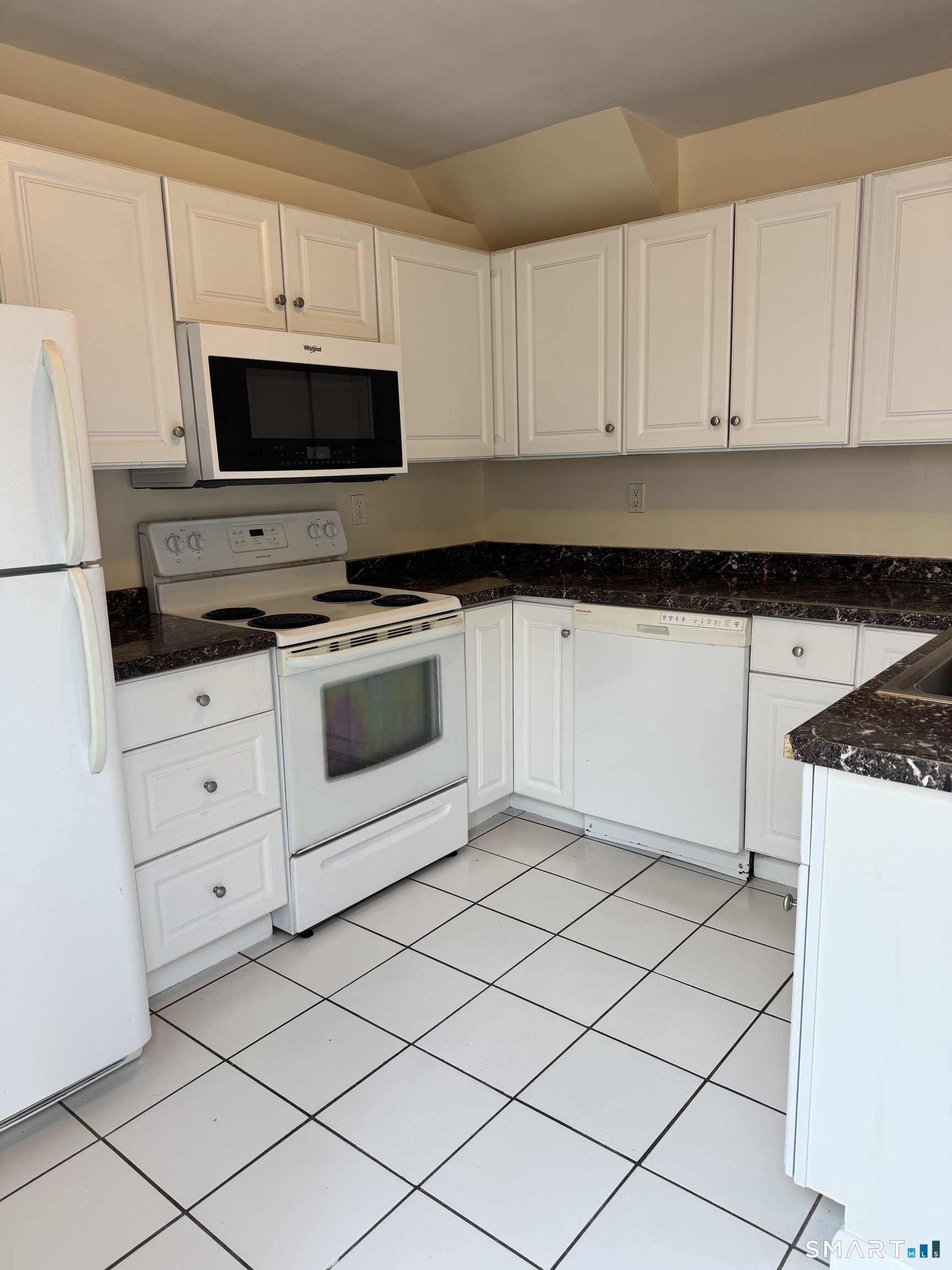 855 Black Rock Turnpike, Unit 1 Fairfield, CT 06825 - Photo 7 of 17 a kitchen with white cabinets appliances and sink