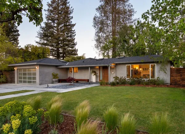 a house view with a sitting space and garden