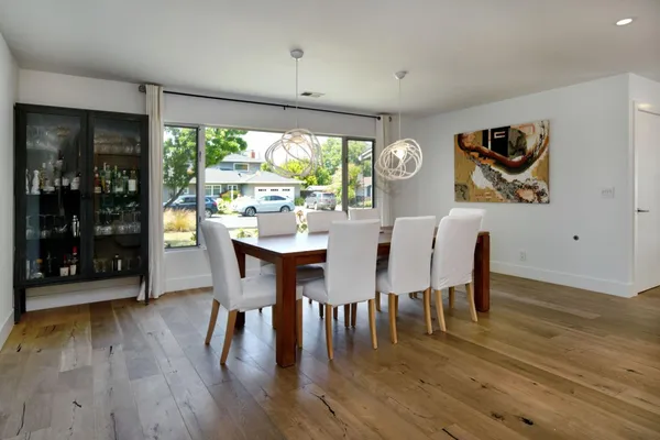 a view of a dining room with furniture window and wooden floor