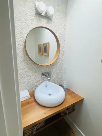 a bathroom with a sink mirror and vanity
