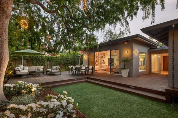 a view of a house with swimming pool and sitting area