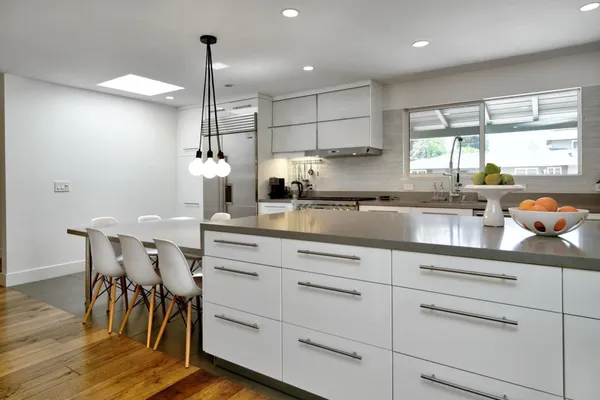 a kitchen with a sink window and cabinets