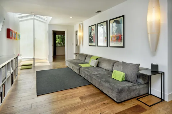 a living room with furniture and wooden floor