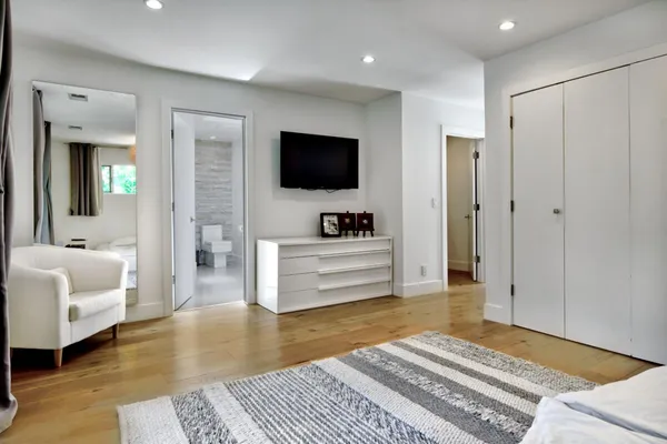 a bedroom with furniture and a flat screen tv