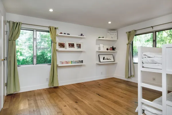 a view of workspace with wooden floor and a window