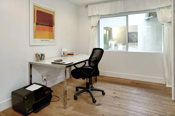 a workspace with furniture and a window