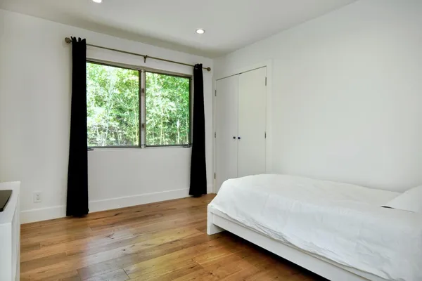a bedroom with a bed and a window