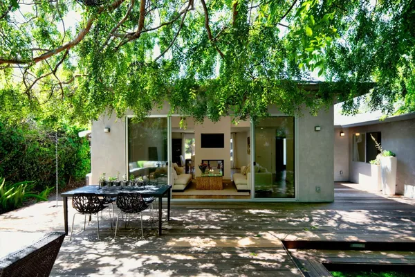 a view of a house with backyard sitting area and garden