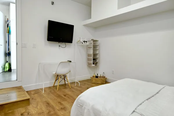 a bedroom with a bed and a view of bathroom