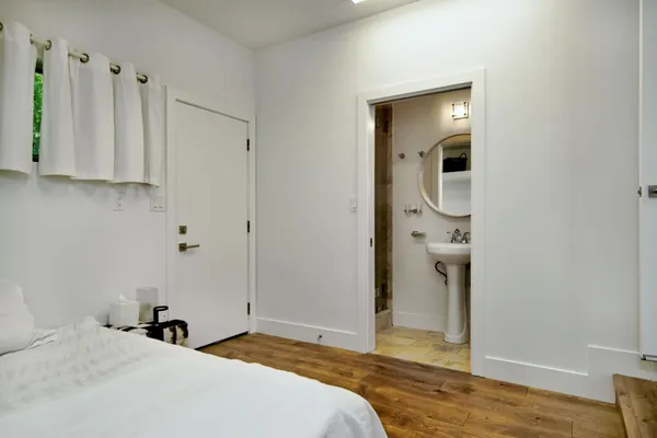 a bathroom with a sink a mirror a vanity and shower