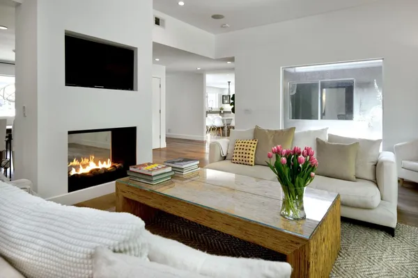 a living room with furniture and a fireplace