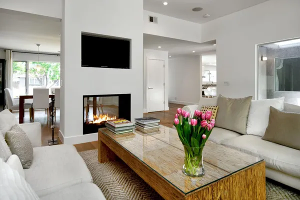 a living room with furniture a fireplace and a flat screen tv