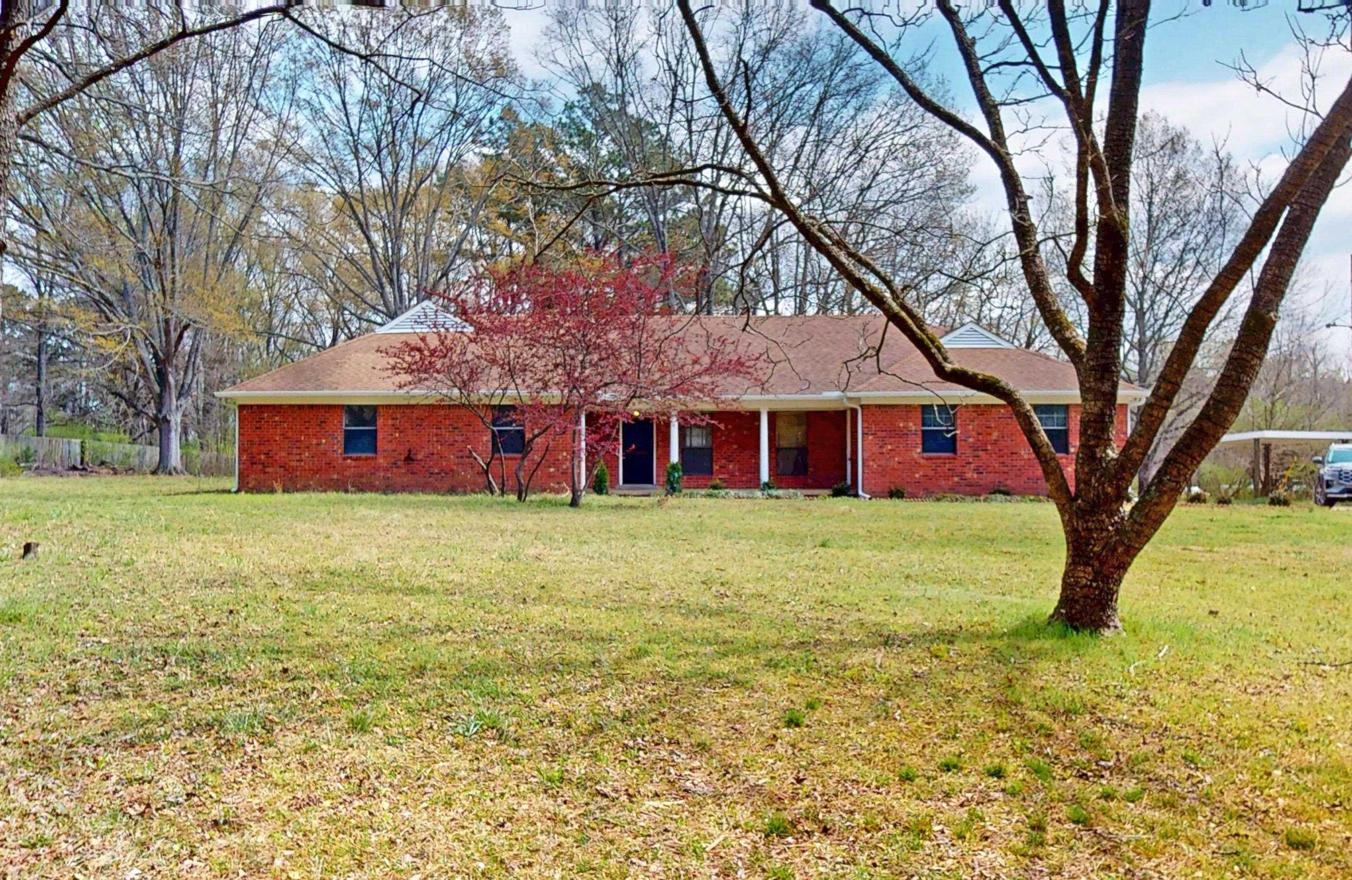 a front view of house with yard and green space