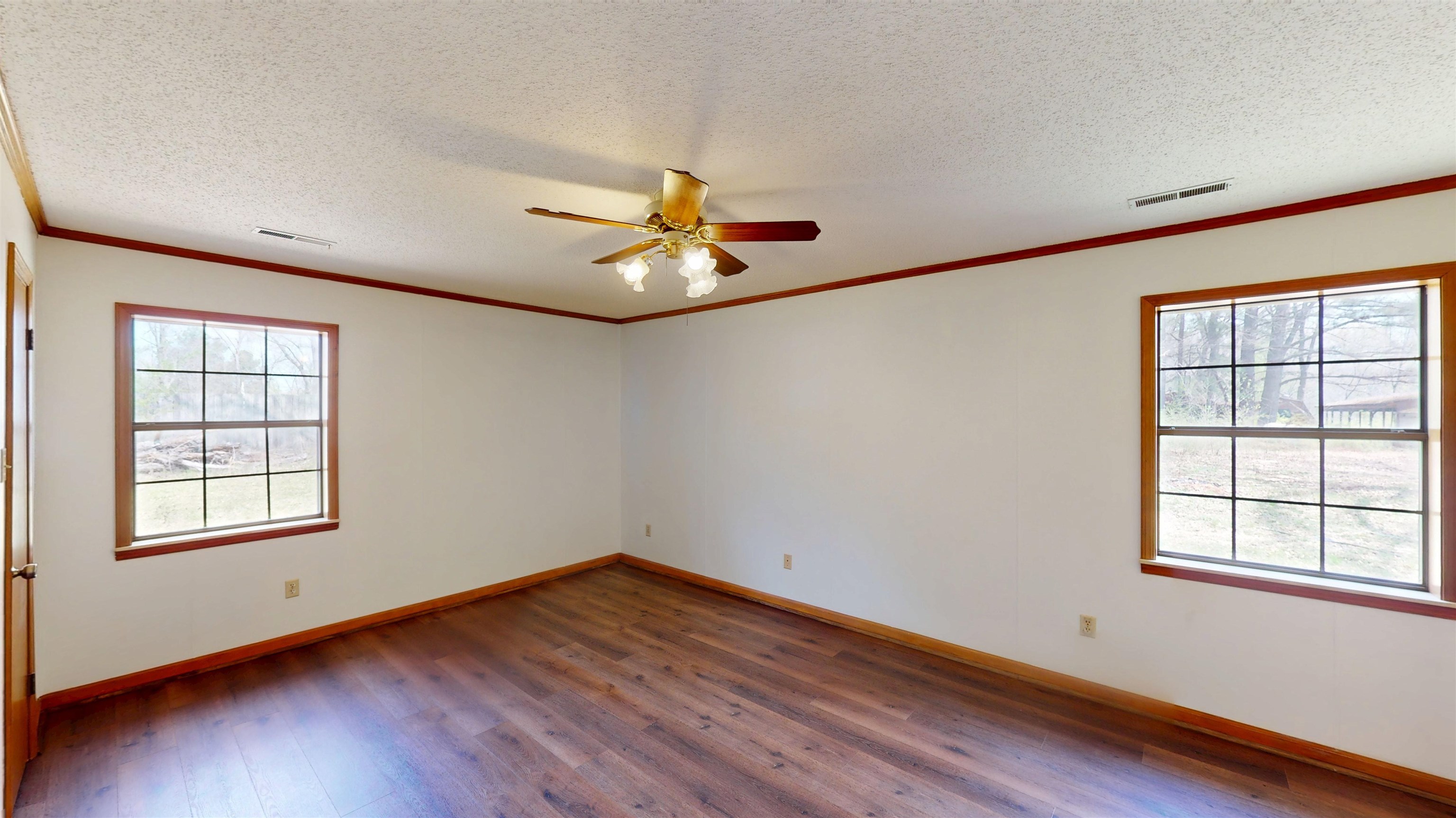 4800 Highway 196 Piperton, TN 38017 - Photo 21 of 37 an empty room with wooden floor chandelier fan and windows