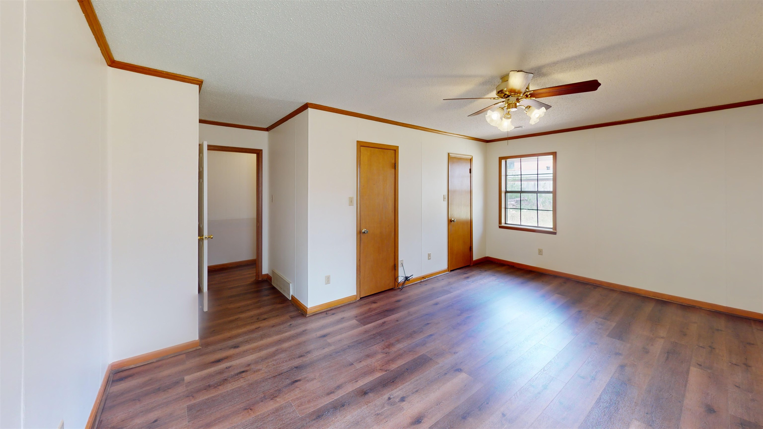 4800 Highway 196 Piperton, TN 38017 - Photo 22 of 37 an empty room with wooden floor chandelier fan and windows