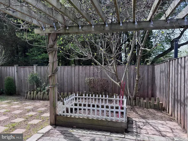 a view of bench with wooden fence