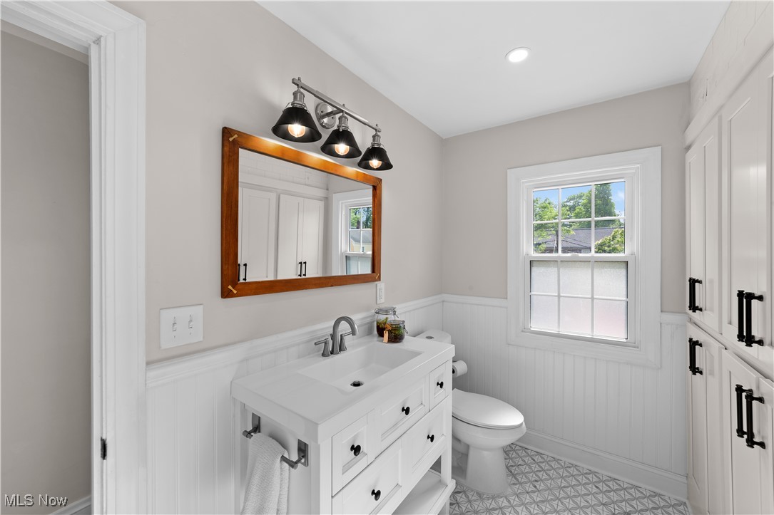 3725 Sutherland Road Shaker Heights, OH 44122 - Photo 12 of 24 Bathroom with wainscoting, vanity, and wood walls
