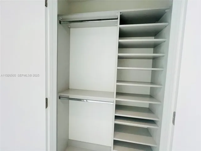 a view of a hallway with a bathroom