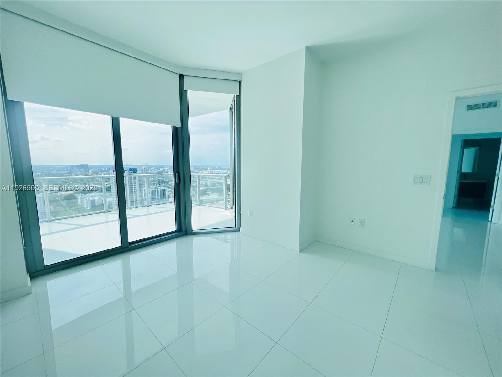 851 Northeast 1st Avenue, Unit 2808 Miami, FL 33132 - Photo 12 of 86 a view of an empty room with a window