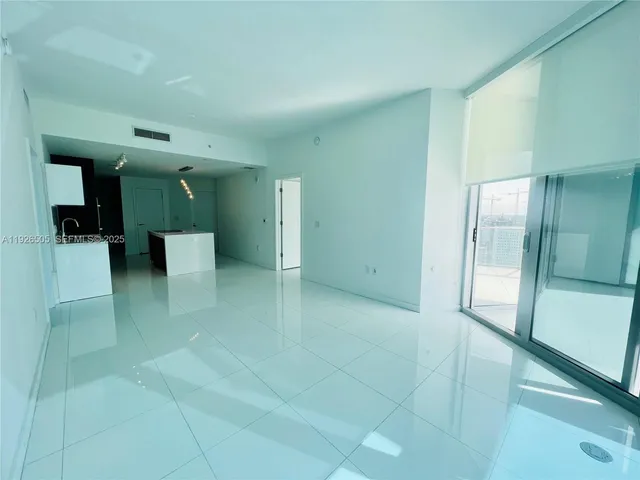 a kitchen with kitchen island a sink a stove and refrigerator
