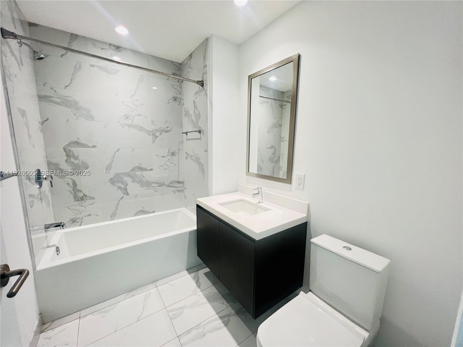 851 Northeast 1st Avenue, Unit 2808 Miami, FL 33132 - Photo 2 of 86 a bathroom with a sink a toilet and shower