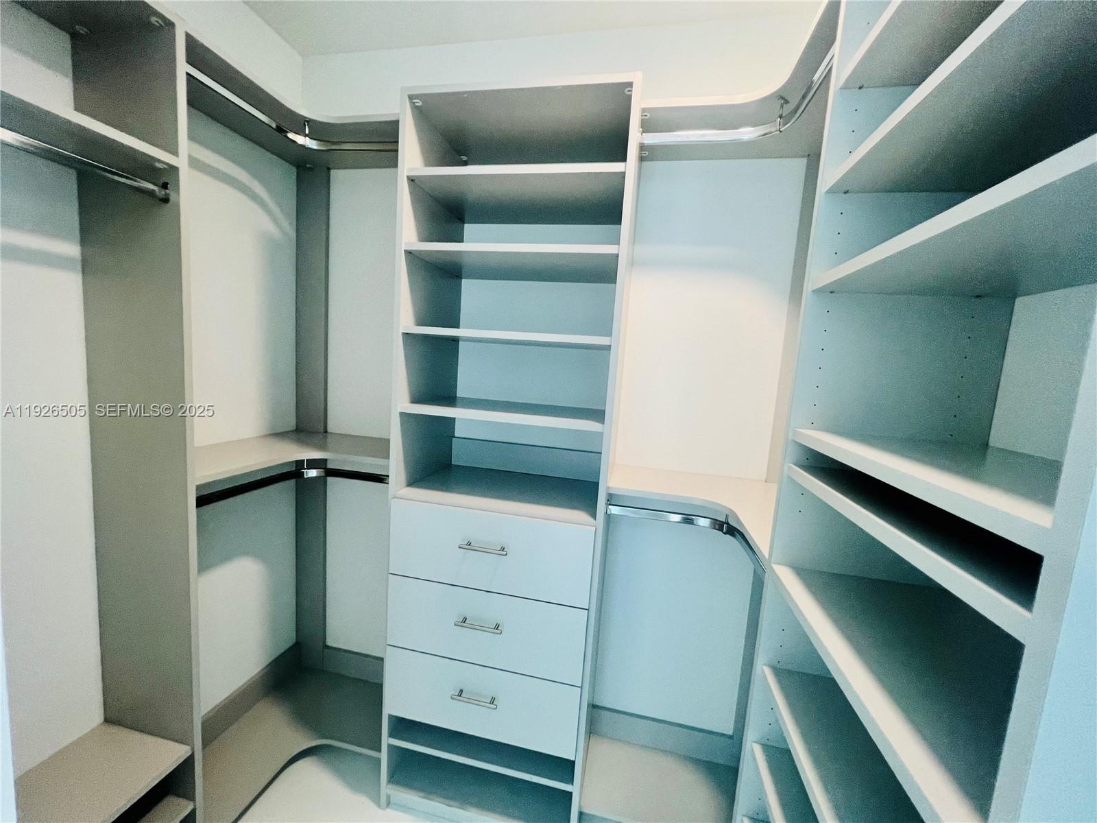 851 Northeast 1st Avenue, Unit 2808 Miami, FL 33132 - Photo 21 of 86 a view of walk in closet with clothes and shoes