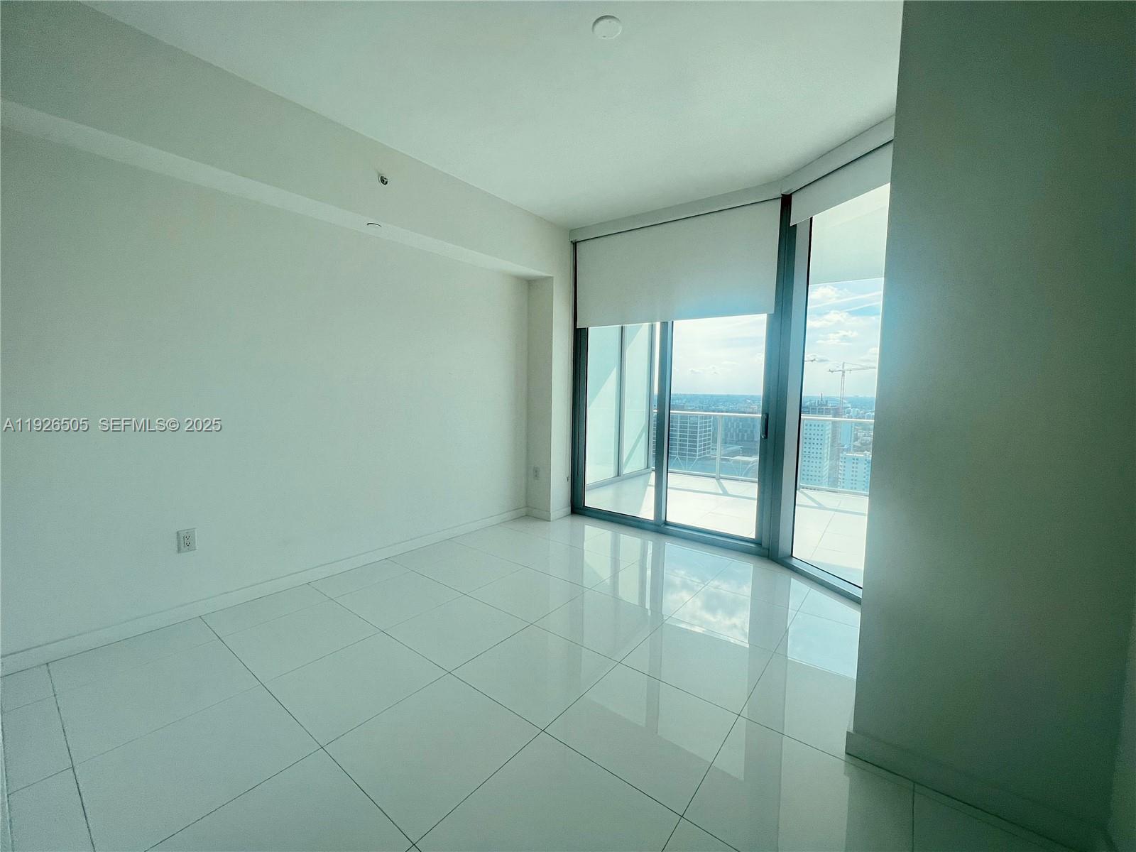 851 Northeast 1st Avenue, Unit 2808 Miami, FL 33132 - Photo 25 of 86 a view of an empty room with glass door