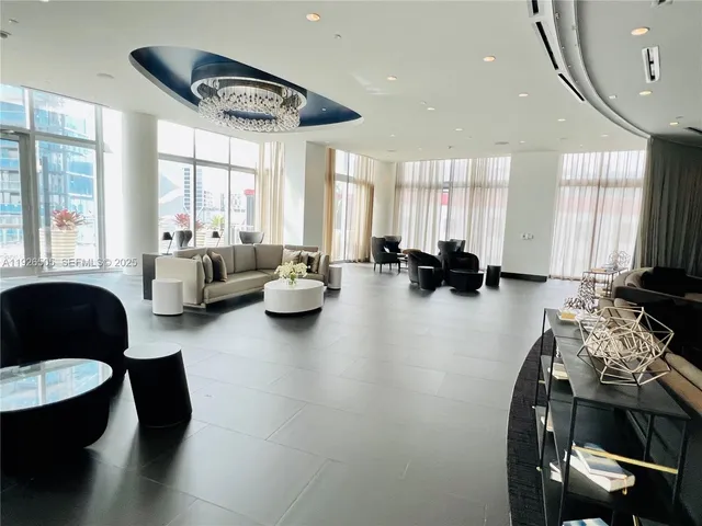 a view of a room with wooden floor and windows