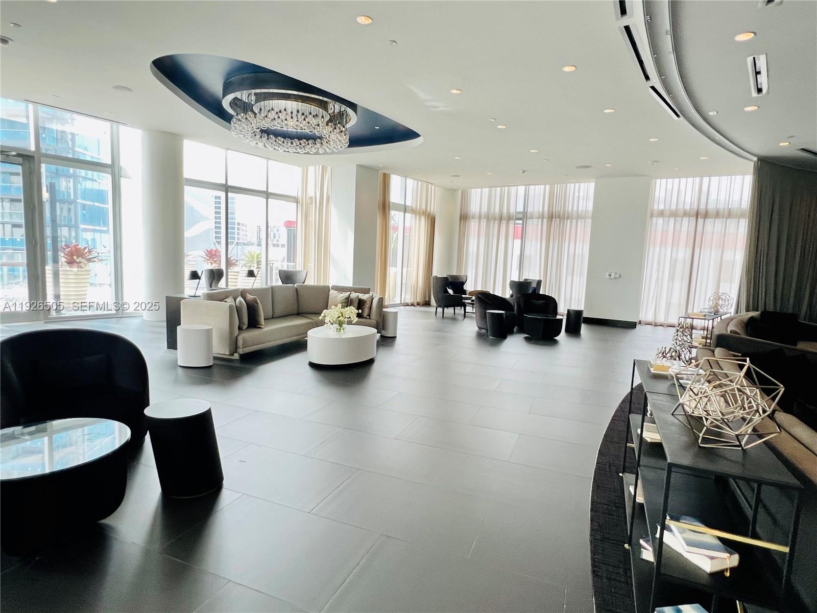 851 Northeast 1st Avenue, Unit 2808 Miami, FL 33132 - Photo 36 of 86 a living room with furniture and a large window