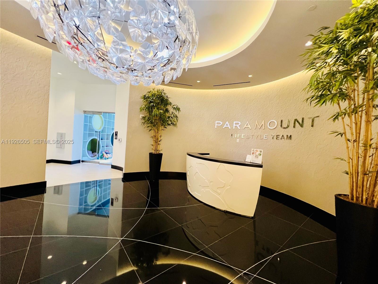851 Northeast 1st Avenue, Unit 2808 Miami, FL 33132 - Photo 70 of 86 a view of a dining room with furniture and a chandelier