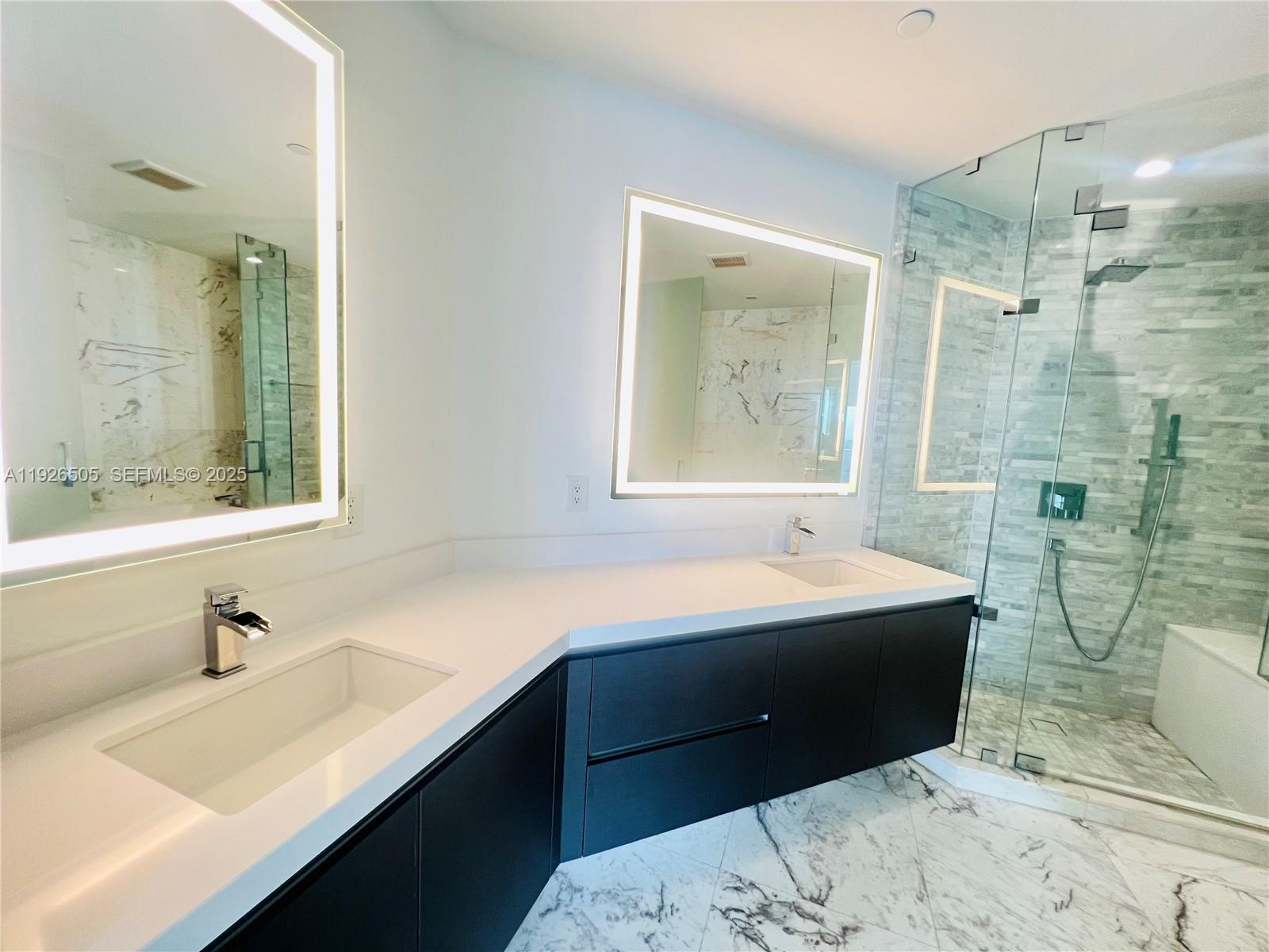 851 Northeast 1st Avenue, Unit 2808 Miami, FL 33132 - Photo 8 of 86 a bathroom with a sink double vanity mirror and a bathtub