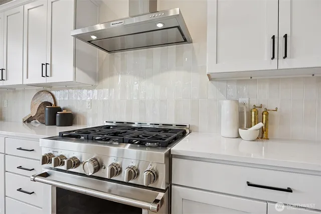 a kitchen with granite countertop a stove and a sink