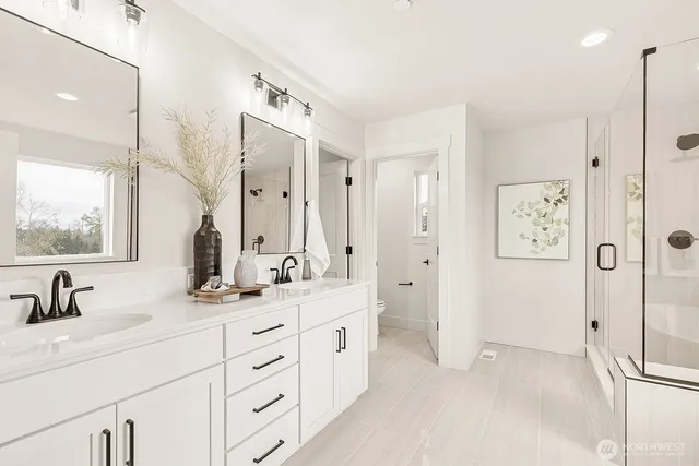 a bathroom with a double vanity sink mirror and double