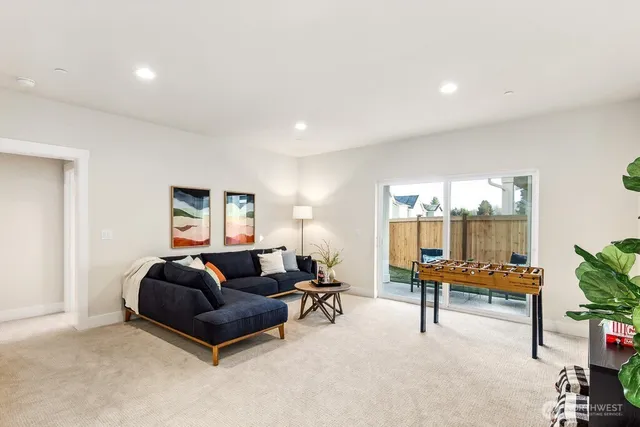 a living room with furniture a piano and a potted plant