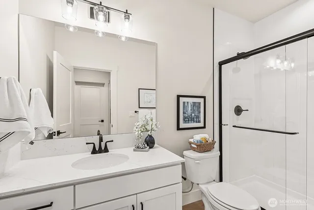 a bathroom with a sink a toilet and shower