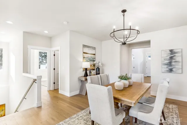 a view of a dining room with furniture wooden floor and chandelier