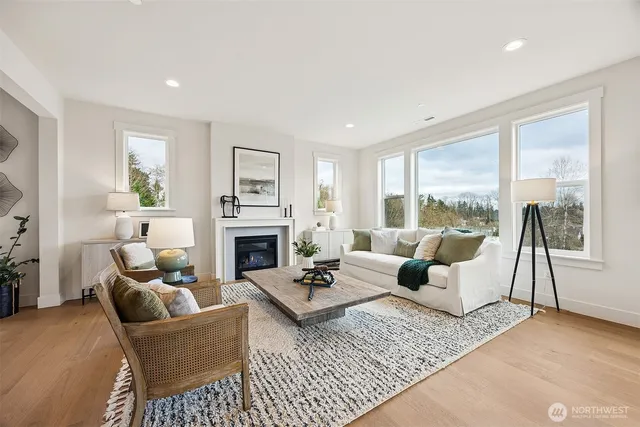 a living room with furniture a large window and a fireplace
