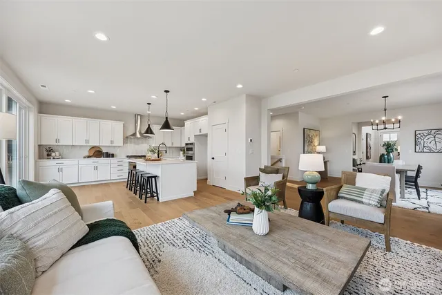 a living room with furniture and a chandelier