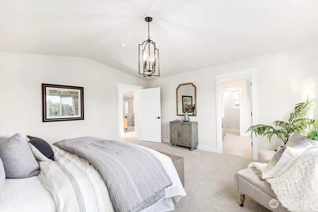 a bedroom with a bed and a chandelier