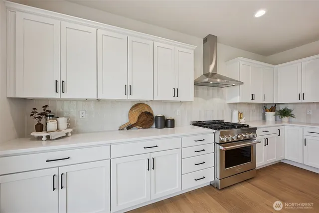 a kitchen with white cabinets and appliances