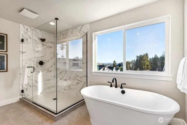 a white bath tub sitting next to a shower