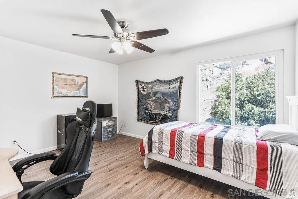 8659 Cordial Road El Cajon, CA 92021 - Photo 11 of 16 a bedroom with a bed a computer on the desk and chair