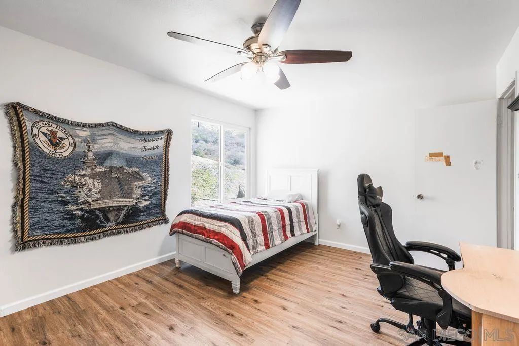 8659 Cordial Road El Cajon, CA 92021 - Photo 12 of 16 a bedroom with furniture and a wooden floor